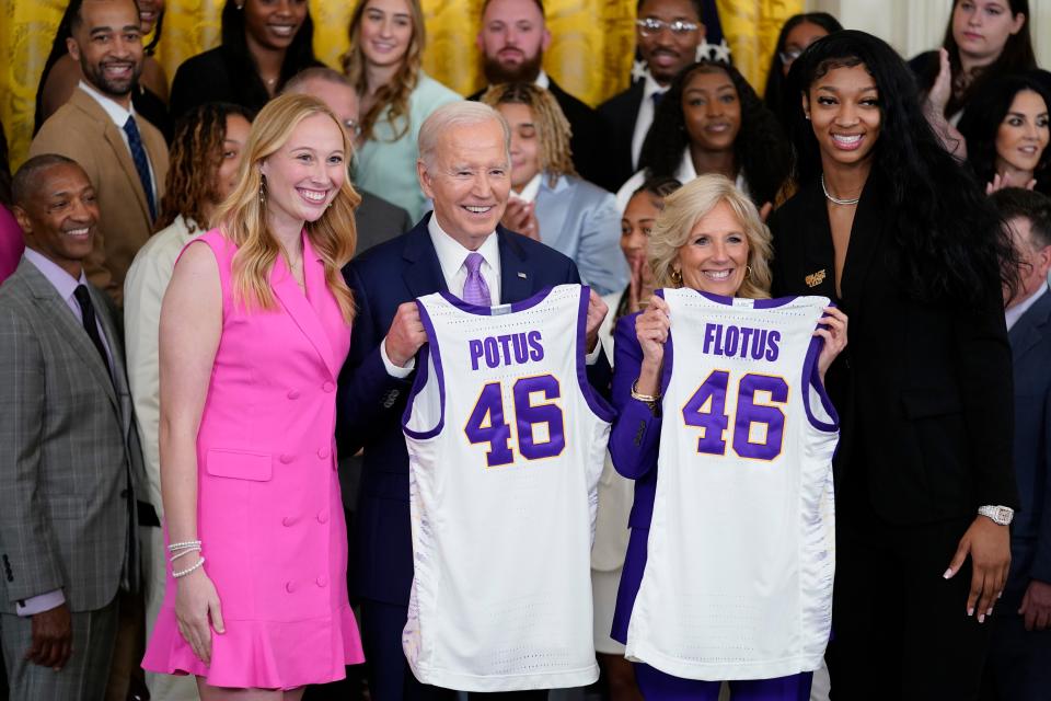 President Joe Biden and first lady Jill Biden are presented with jerseys by LSU women's basketball team captains Angel Reese, right, and Emily Ward, left, during an event to honor the 2023 NCAA national championship team in the East Room of the White House, Friday, May 26, 2023, in Washington.