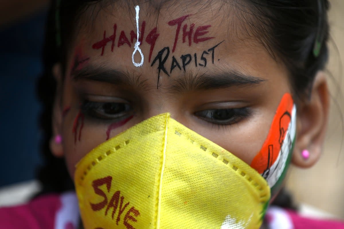 FIle image: A student gets her face painted to condemn the alleged gang-rape of 19-year-old woman victim by four men in Bool Garhi village of Uttar Pradesh state, in Mumbai (AFP via Getty Images)