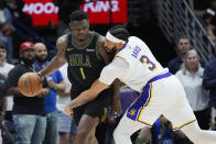 New Orleans Pelicans forward Zion Williamson (1) works the ball against Los Angeles Lakers forward Anthony Davis (3) in the first half of an NBA basketball game in New Orleans, Sunday, April 14, 2024. (AP Photo/Gerald Herbert)
