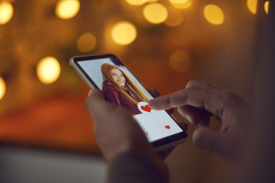 a hand touching a phone screen