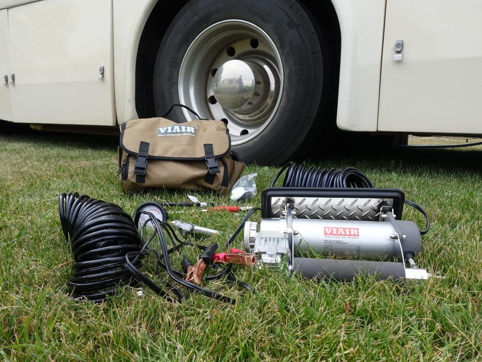 Air compressor kit in the grass in front of the RV