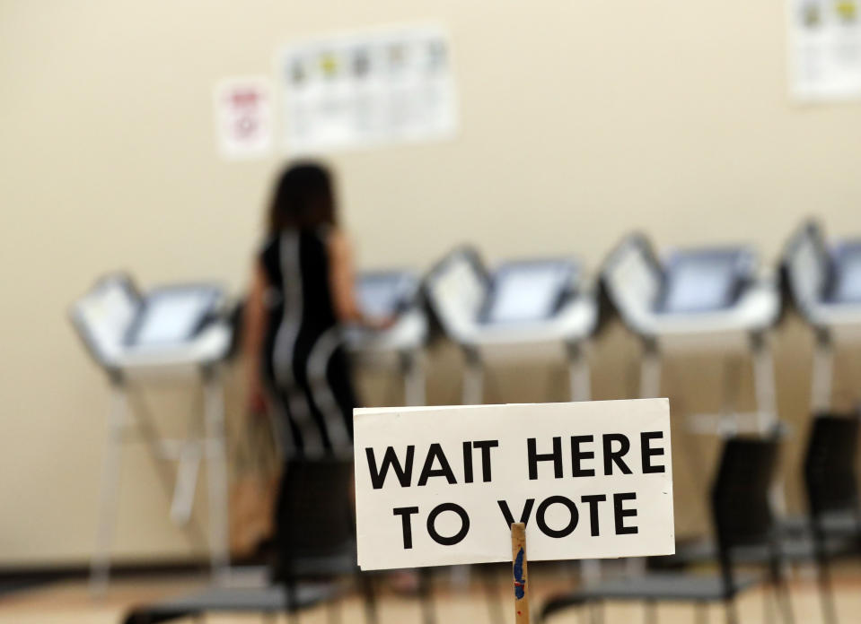 FILE - In this May 9, 2018, file photo, a woman votes in Sandy Springs, Ga. It’s been more than three years since Russia's sweeping effort to interfere in U.S. elections through disinformation on social media, stolen campaign emails and attacks on voting systems. U.S. officials have made advances in trying to prevent similar attacks from undermining the 2020 vote, but challenges remain. (AP Photo/John Bazemore, File)