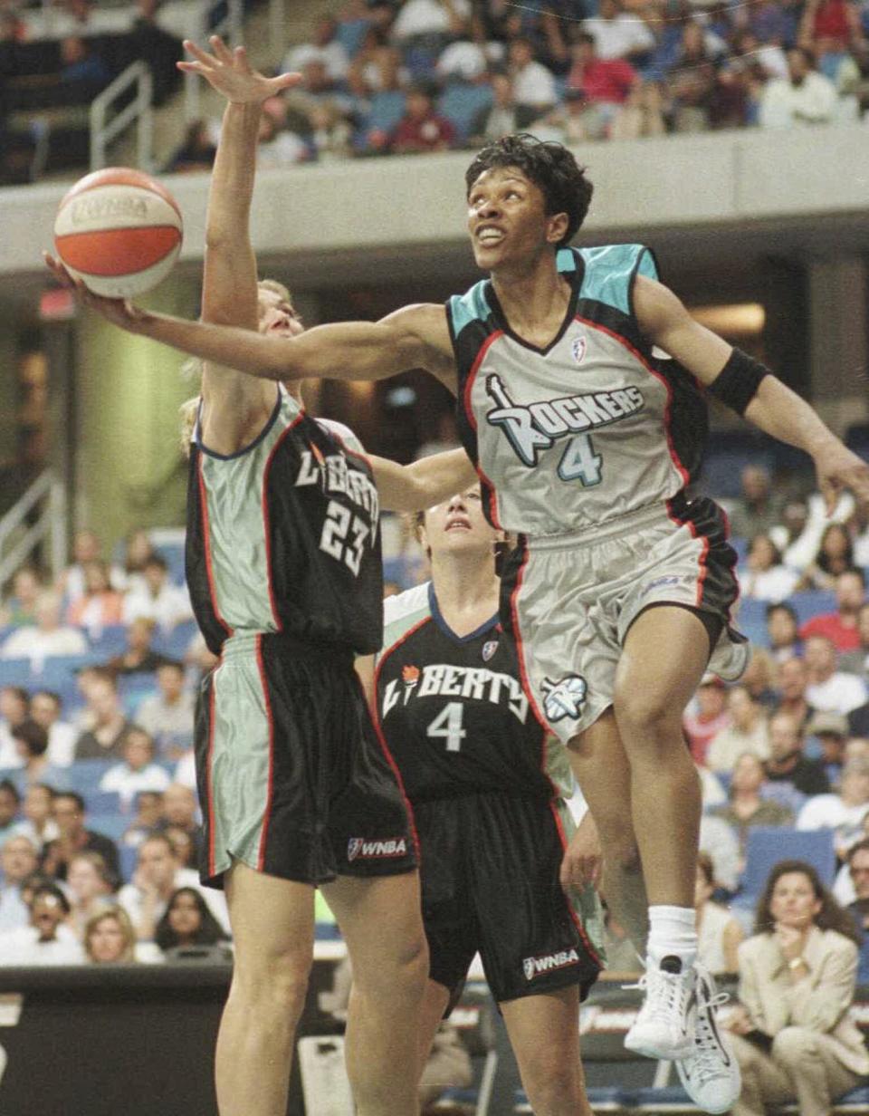 FILE - Lynette Woodard (4) of the Cleveland Rockers gets off a shot as Sue Wicks (23) of the New York Liberty tries to defend during the first half of a WNBA game in Cleveland, Ohio, Monday, July 14, 1997. Until 1997, there was no WNBA. Media coverage was minimal. The madness of March was almost exclusively the men's domain. (AP Photo/Phil Long, FIle)