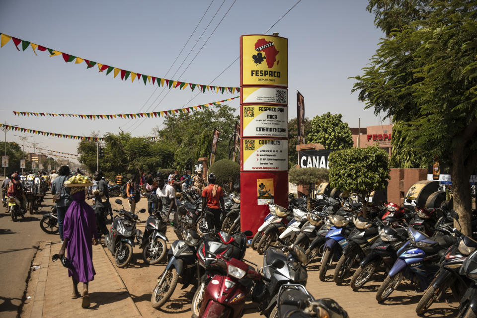 Motorcycles are parked in front of the headquarters of the FESPACO (Pan-African Film and Television Festival) in Ouagadougou, Burkina Faso, Friday, Feb. 24, 2023. Most film festivals can be counted on to provide entertainment, laced with some introspection. The weeklong FESPACO that opens Saturday in violence-torn Burkina Faso's capital goes beyond that to also offer hope, and a symbol of endurance. (AP Photo/Sophie Garcia)