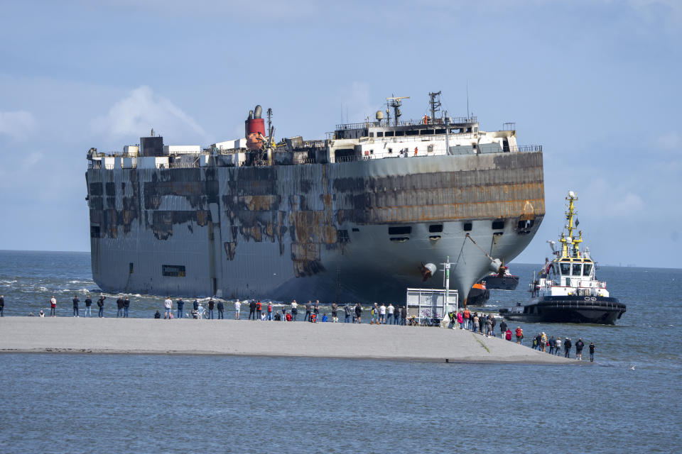 Stricken cargo ship Fremantle Highway, that caught fire while transporting thousands of cars, including nearly 500 electric vehicles, from Germany to Singapore, is towed into the port of Eemshaven, the Netherlands, on Thursday, Aug. 3, 2023. The ship that burned for almost a week close to busy North Sea shipping lanes and a world renowned migratory bird habitat will be salvaged at the northern Dutch port. (AP Photo/Peter Dejong)