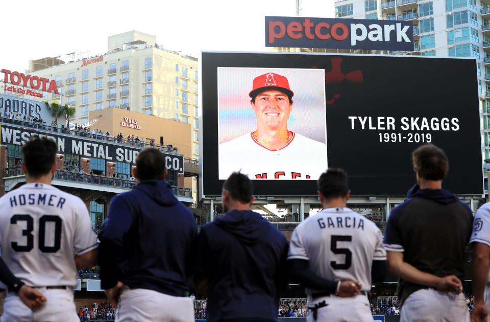 Players for the San Diego Padres and San Francisco Giants stand during a moment of silence for pitcher Tyler Skaggs of the Los Angeles Angels of Anaheim at PETCO Park on July 01, 2019 in San Diego, California.  Skaggs passed away in his hotel room earlier in the day in Texas.  (Photo by Sean M. Haffey/Getty Images)