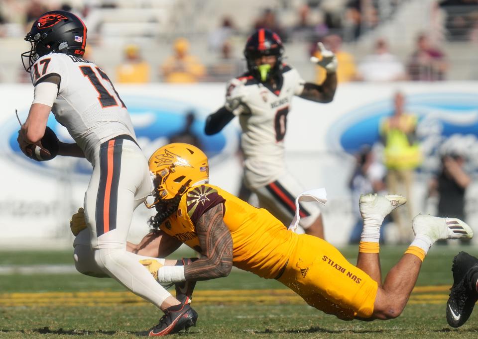 Nov 19, 2022; Tempe, Arizona, USA; Arizona State Sun Devils linebacker Merlin Robertson (8) sacks Oregon State Beavers quarterback Ben Gulbranson (17) at Sun Devil Stadium in Tempe. Mandatory Credit: Joe Rondone-Arizona Republic