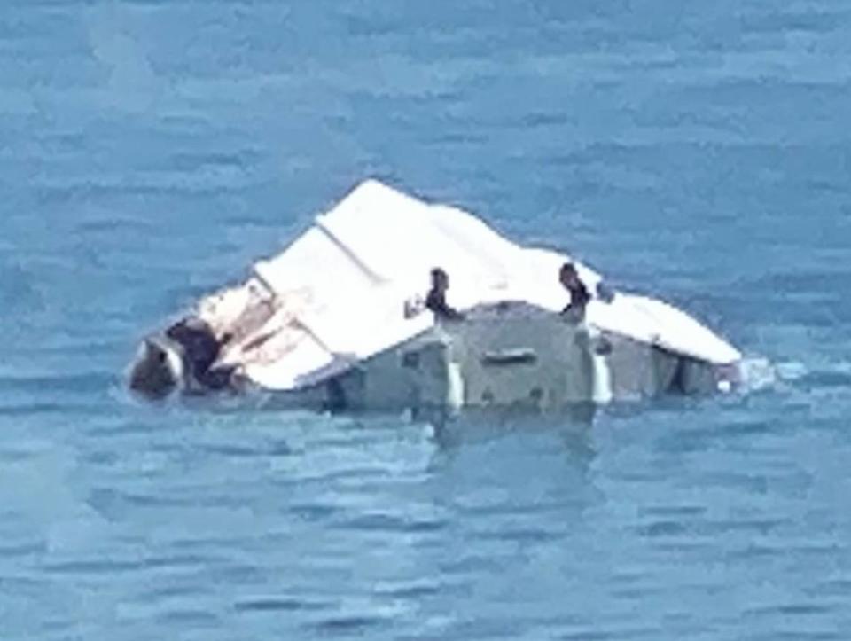 The boat that struck a channel marker near North Key Largo on the 2022 Labor Day weekend capsized, throwing all aboard into the water. This photo taken on the scene, shows the upside down vessel also had heavy damage along its starboard, or right, side. One young girl died in the wreck and another was left permanently disabled. Provided to the Miami Herald