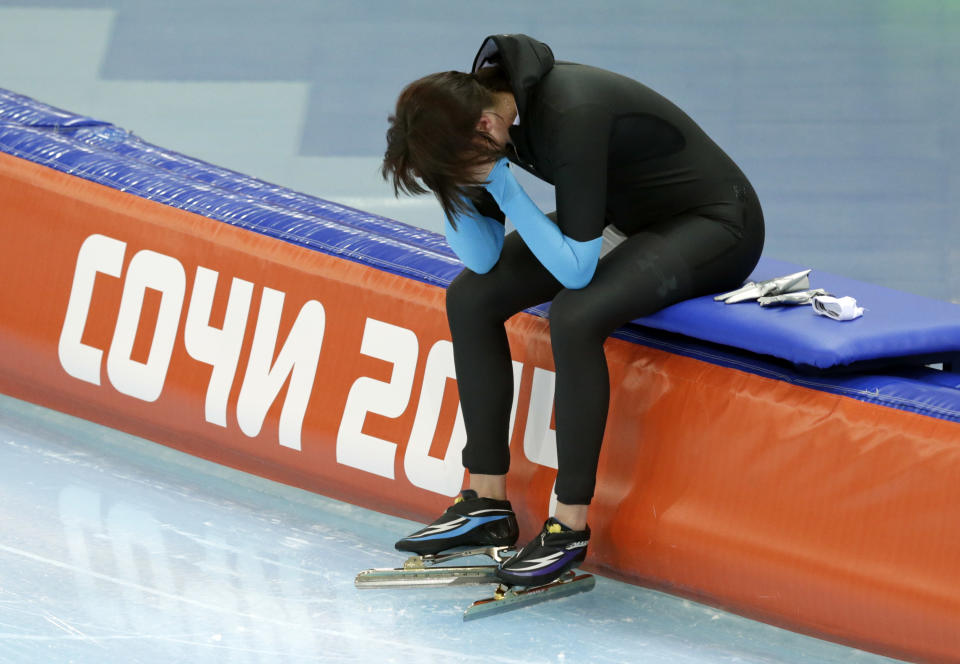 Heather Richardson of the U.S. cups her face and looks down after competing in the women's 1,500-meter race at the Adler Arena Skating Center during the 2014 Winter Olympics in Sochi, Russia, Sunday, Feb. 16, 2014. (AP Photo/Matt Dunham)