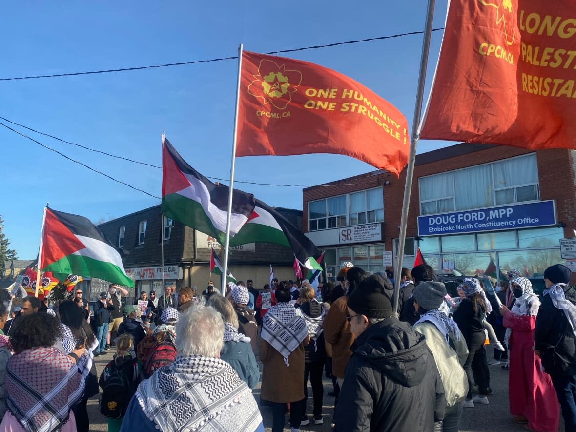 More than 100 people gathered outside the Etobicoke constituency office of Ontario Premier Doug Ford on Friday afternoon to protest the ban on keffiyehs at Queen's Park. (Olivia Bowden/CBC - image credit)