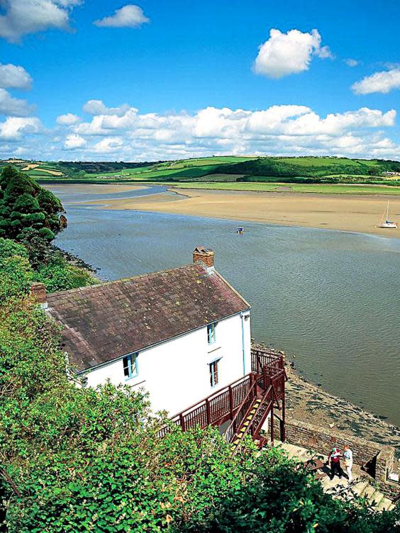 The Laugharne boat house where Dylan Thomas lived and worked in the final years of his life, looking out over the estuary and the trees beyond, which is said to be the inspiration for Under Milk Wood. (Visit Wales)