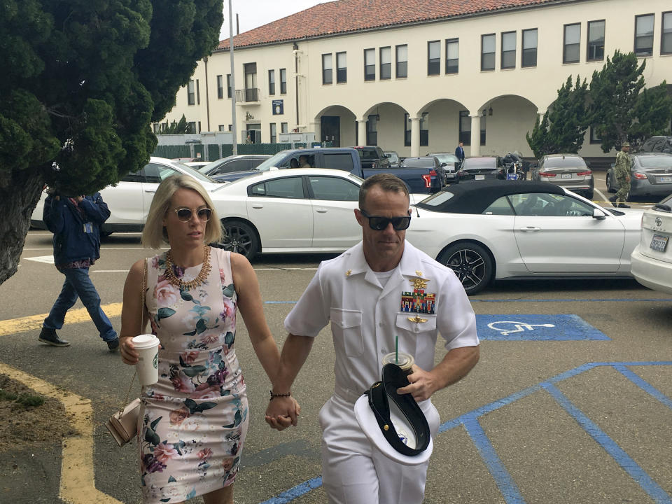 Navy Special Operations Chief Edward Gallagher, right, walks with his wife, Andrea Gallagher, as they arrive to military court on Naval Base San Diego, Thursday, June 20, 2019, in San Diego. More former SEALs were expected to testify on Thursday in the case against Gallagher, who has pleaded not guilty to murder and attempted murder stemming from his 2017 tour of duty in Iraq. (AP Photo/Julie Watson)