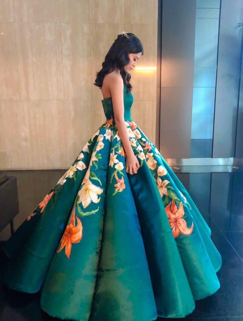 Ciara Gan, a recent high school graduate in the Philippines, poses with the dress that has been called an 