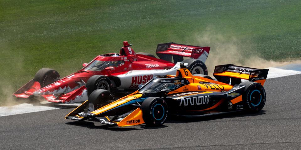 Arrow McLaren SP driver Pato O'Ward (5) and Chip Ganassi Racing driver Marcus Ericsson (8) on the opening lap at the Indianapolis Motor Speedway, Saturday, July 30, 2022, during the Gallagher Grand Prix.