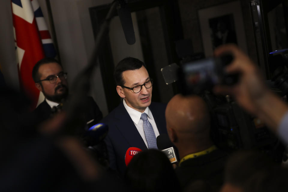 Polish Prime Minister Mateusz Morawiecki speaks with the media at the end of an EU summit in Brussels, Friday, Dec. 13, 2019. European Union leaders gathered for their year-end summit and discussed climate change funding, the departure of the UK from the bloc and their next 7-year budget. (AP Photo/Francisco Seco)