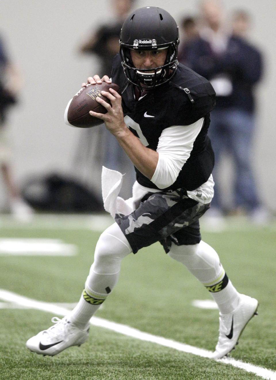 Texas A&M quarterback Johnny Manziel passes the ball during a drill at pro day for NFL football representatives in College Station, Texas, Thursday, March 27, 2014. (AP Photo/Patric Schneider)