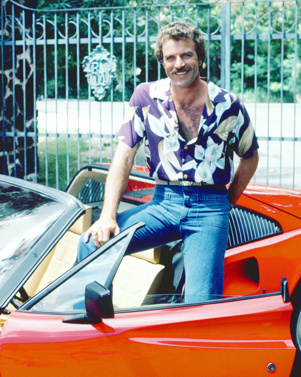 Tom Selleck as the titular investigator in the television series 'Magnum, P.I.', circa 1985. He is posing with his red Ferrari 308. (Photo by Silver Screen Collection/Archive Photos/Getty Images)