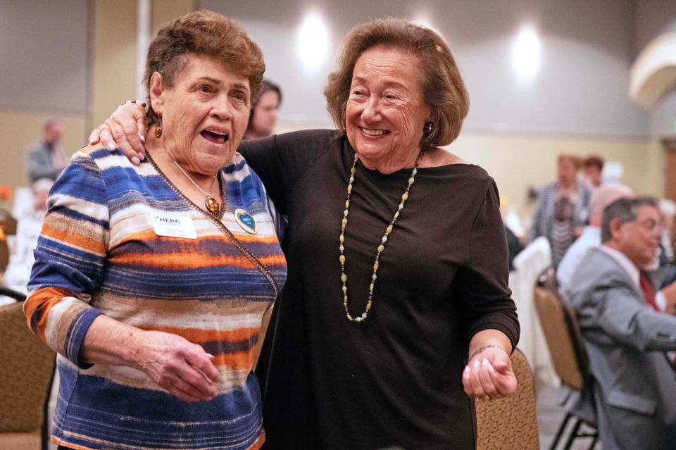 Edith Pump (left) and Eva Zaret (right) hold each other while they sway and sing along to a song during a dinner honoring Holocaust survivors hosted by The Nathan and Esther Pelz Holocaust Education Resource Center on Sept. 28, 2023 in Whitefish Bay, Wis.