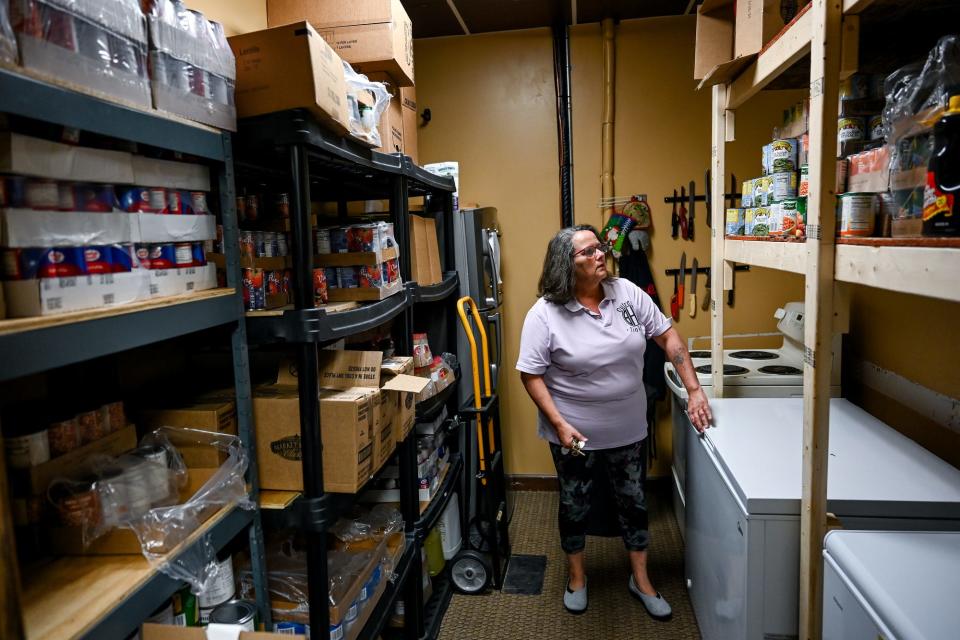 Cheril Glasslee looks for items in the food pantry at The Bread House South on Friday, Aug. 12, 2022, in Lansing.
