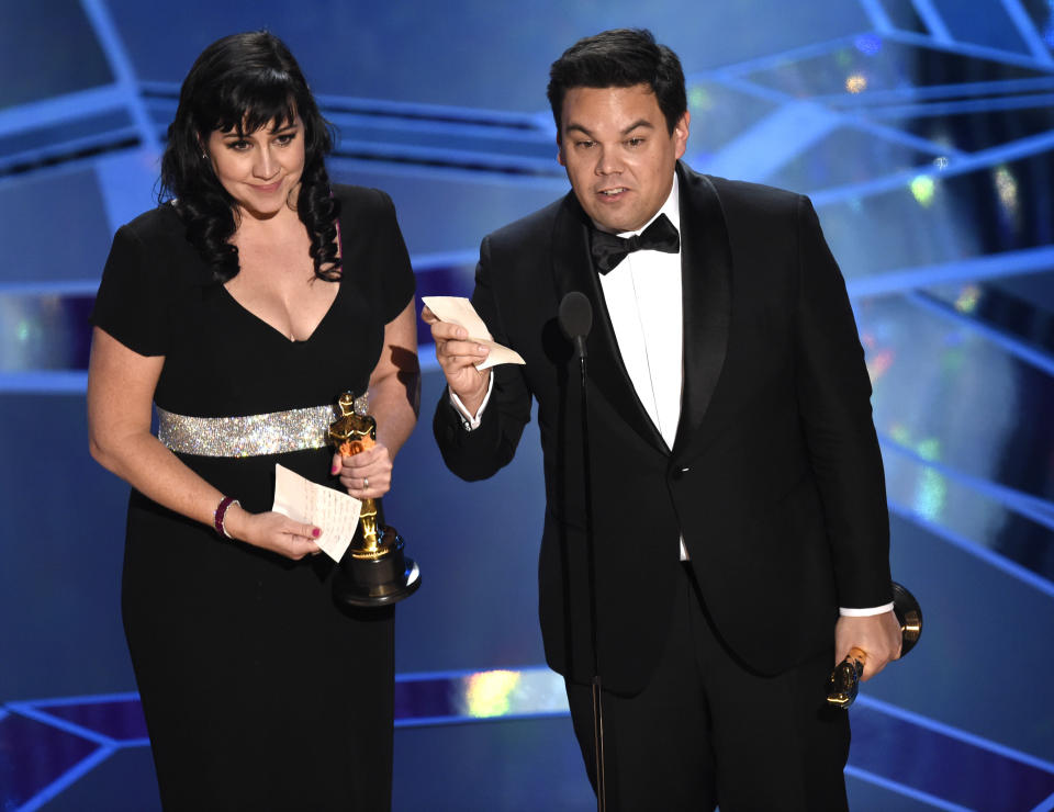 Kristen Anderson-Lopez, left, and Robert Lopez accept the award for best original song for “Remember Me” from “Coco” at the Oscars on Sunday, March 4, 2018, at the Dolby Theatre in Los Angeles. (Photo by Chris Pizzello/Invision/AP)