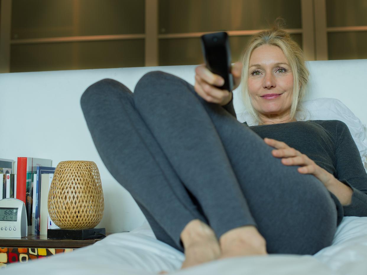 Woman watching TV in bed