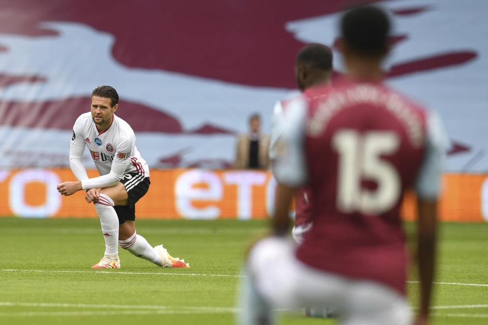 A sport plagued by racism acknowledged its return on Wednesday with a tribute to George Floyd. (Paul Ellis/Pool via AP)