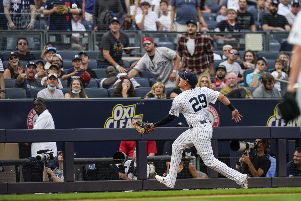 New York Yankees' Gio Urshela chases a ball hit by Tampa Bay Rays' Austin Meadows for an out during the sixth inning of a baseball game Sunday, Oct. 3, 2021, in New York. (AP Photo/Frank Franklin II)
