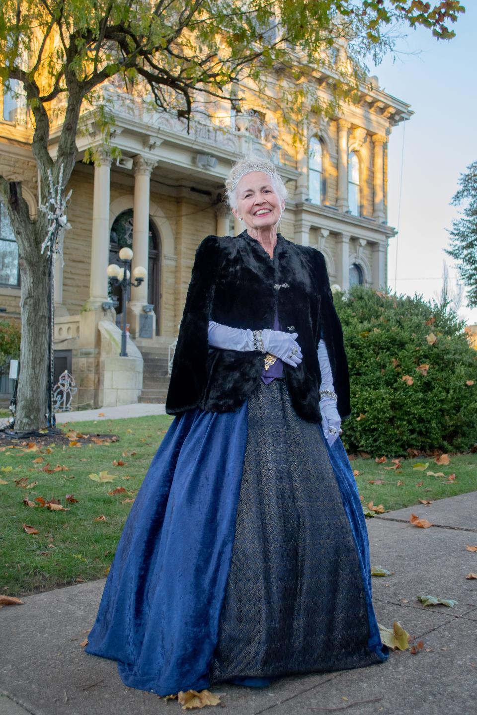 Connie Humphrey dressed as Queen Victoria prepares to welcome the holiday season to Guernsey County at the Dickens Victorian Village opening ceremony.