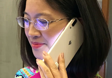 A woman tries a Vingroup's Vsmart phone during the launching ceremony in Ho Chi Minh City, Vietnam December 14, 2018. REUTERS/Mai Nguyen