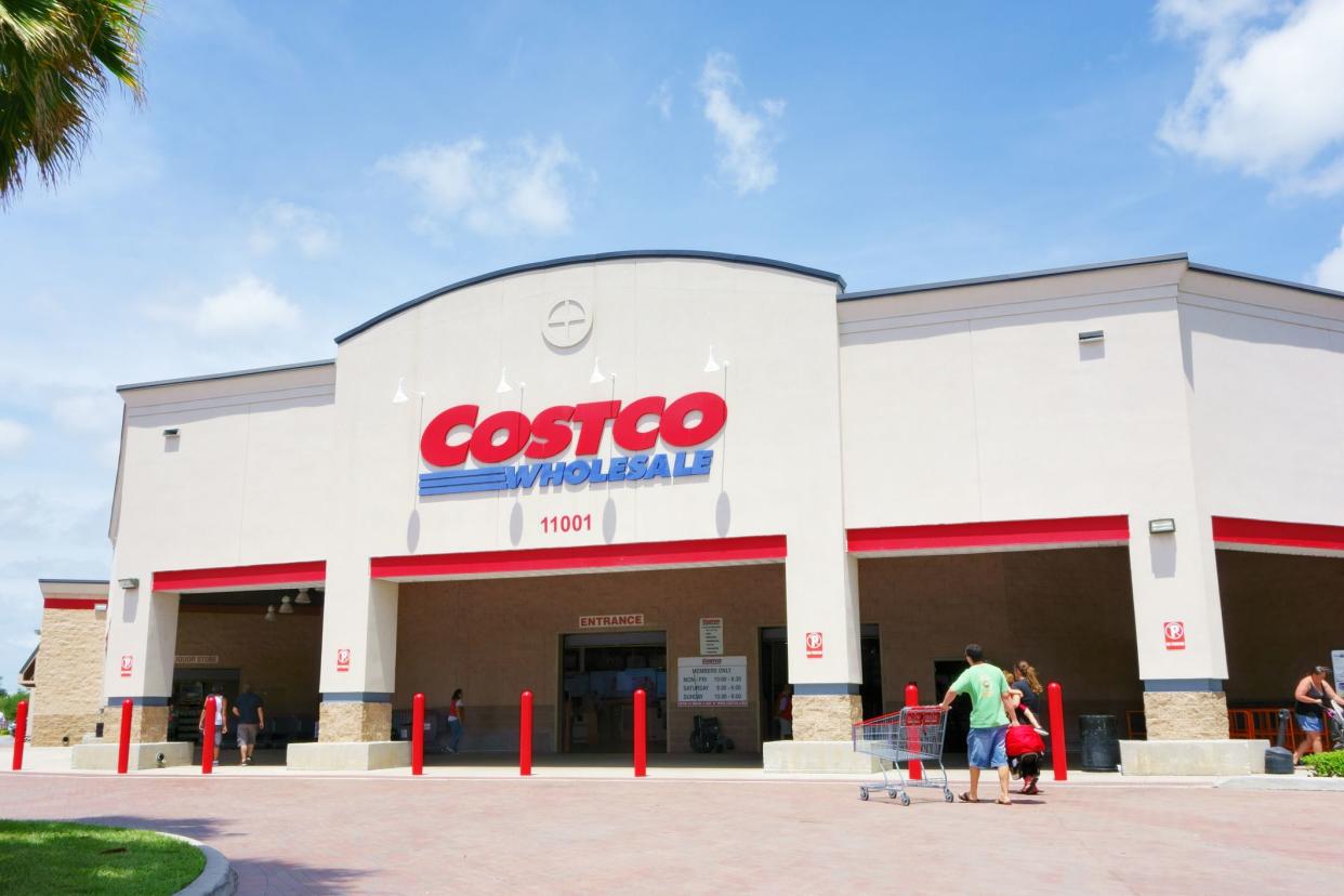 people entering entrance of Costco Wholesale Store, West Palm Beach, Florida on a sunny, summer day