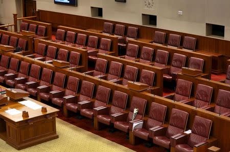 A bouquet of flowers is seen on the seat of the late first prime minister of Singapore Lee Kuan Yew during a special parliamentary session at the Parliament House in Singapore March 26, 2015. REUTERS/Ministry of Communications and Information of Singapore/Handout