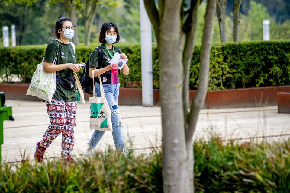 ROTTERDAM, NETHERLANDS - 2020/08/17: Students seen wearing facemasks on the information market during Eurekaweek. Eurekaweek also known as the introduction week for the new academic year for Erasmus University Rotterdam where students get to know their university. The Eurekaweek will take place in a different form this year due to the coronavirus pandemic, it will be divided into three physical days and one online day however all activities will be in line with measures set by government for Covid-19. (Photo by Robin Utrecht/SOPA Images/LightRocket via Getty Images)