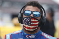 Driver Bubba Wallace walks to his car in the pits of the Talladega Superspeedway prior to the start of the NASCAR Cup Series auto race at the Talladega Superspeedway in Talladega Ala., Monday June 22, 2020. In an extraordinary act of solidarity with NASCAR’s only Black driver, dozens of drivers pushed the car belonging to Bubba Wallace to the front of the field before Monday’s race as FBI agents nearby tried to find out who left a noose in his garage stall over the weekend. (AP Photo/John Bazemore)