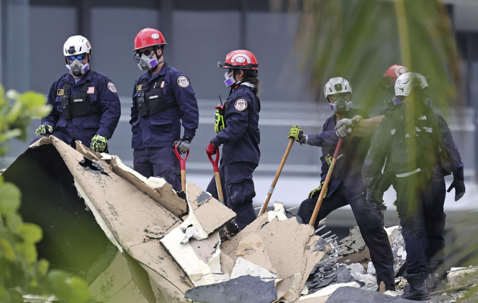 Search and rescue personnel search for survivors through the rubble at the Champlain Towers South Condo in Surfside, Fla., Friday, June 25, 2021. The apartment building partially collapsed on Thursday, June 24. (David Santiago/Miami Herald via AP)