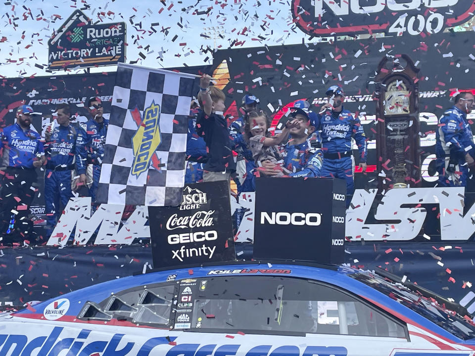 Kyle Larson celebrates with his family after winning the NASCAR Cup Series auto race, Sunday, April 16, 2023, at Martinsville Speedway in Henry County, Va. (AP Photo/Steve Reed).