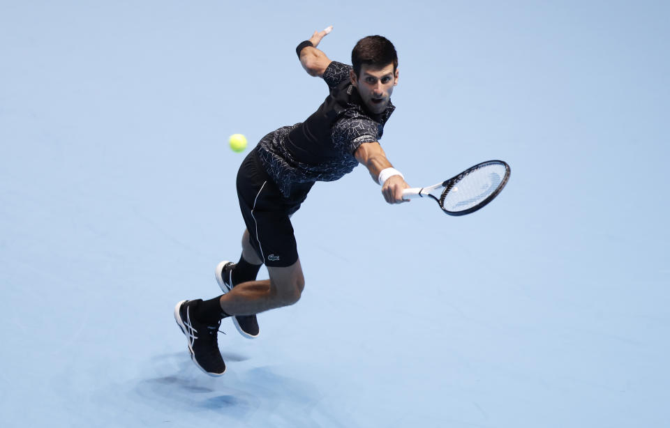 Novak Djokovic of Serbia plays a return to Alexander Zverev of Germany during their ATP World Tour Finals men's singles tennis match at the O2 arena in London, Wednesday, Nov. 14, 2018. (AP Photo/Alastair Grant)