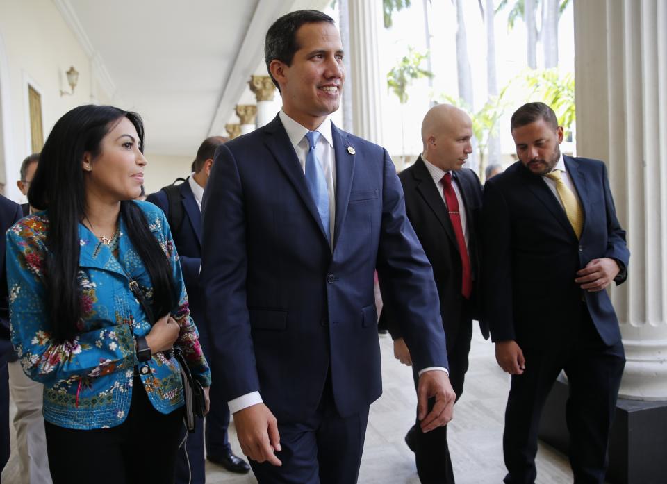 FILE - In this Sept. 17, 2019, file photo, Venezuelan opposition leader and self-proclaimed interim president of Venezuela Juan Guaido walks with lawmaker Delsa Solorzano after the weekly session at the National Assembly in Caracas, Venezuela. The Trump administration is more than tripling U.S. support for pro-democracy work in Venezuela and for the first time will give funds to Guaido as he attempts to set up an interim government. (AP Photo/Ariana Cubillos, File)