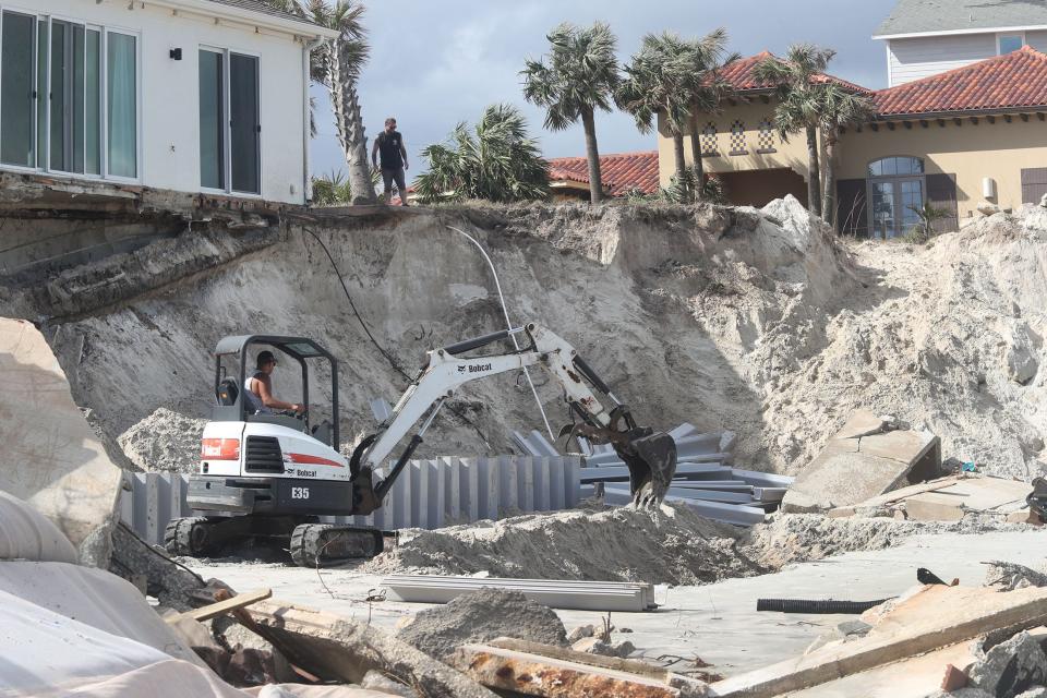 A crew gets to work at a Hurricane Nicole damaged home, Friday November 11, 2022 in Wilbur-by-the-Sea.