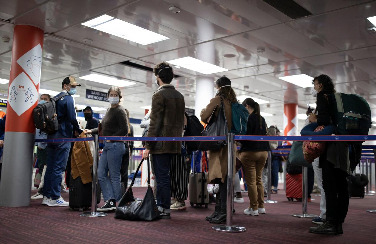 Passengers queue up at the passport control area of Roissy Charles de Gaulle airport in Roissy, near Paris.