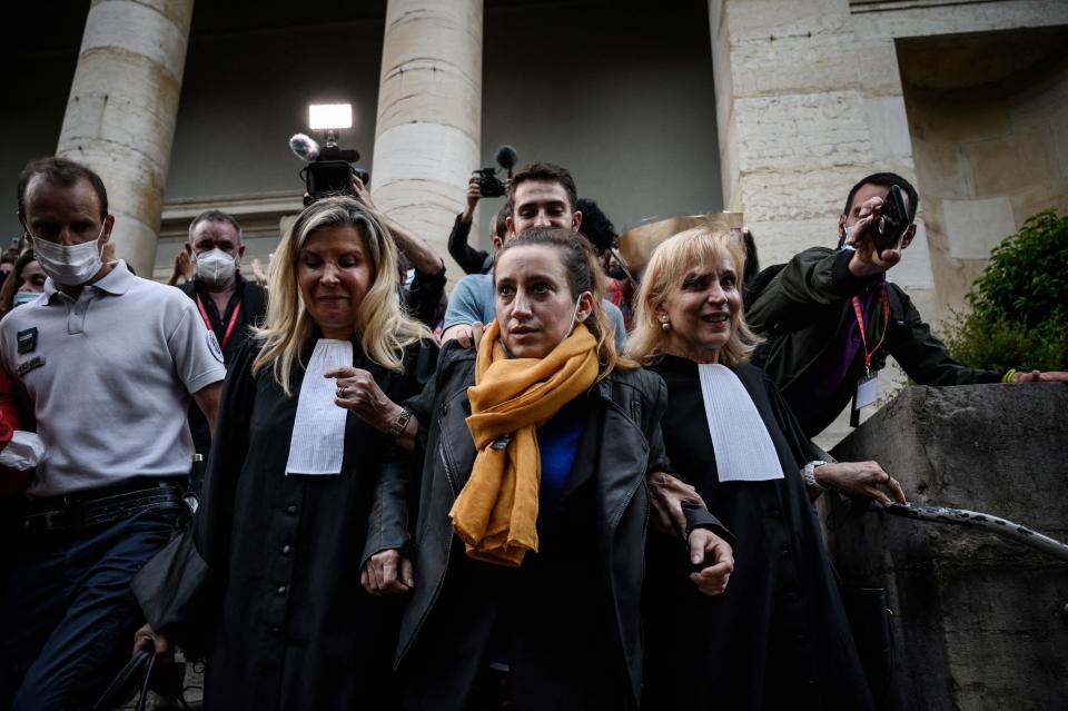 Valerie Bacot (C) leaves Chalon-sur-Saone Courthouse, flanked by relatives and lawyers applauded and congratulated by passers-by, in Chalon-sur-Saone, central-eastern France, on June 25, 2021 at the end of her trial on charges of murdering her stepfather turned husband, who she claimed abused her since she was 12. - Valerie Bacot was sentenced on June 25, 2021 to a symbolic four-year prison term, three of which were suspended, for the murder of her pimp husband, allowing her to walk out of court free, having already spent a year in custody. (Photo by JEFF PACHOUD / AFP) (Photo by JEFF PACHOUD/AFP via Getty Images)