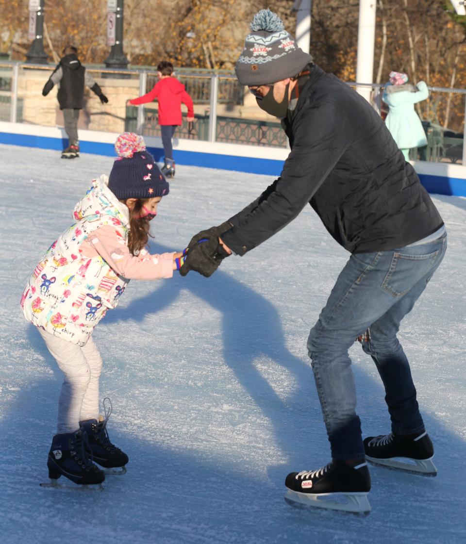Frida Bee, 6, learns to skate with her father, Matt Bee, on Nov. 28, 2020, in Cuyahoga Falls.