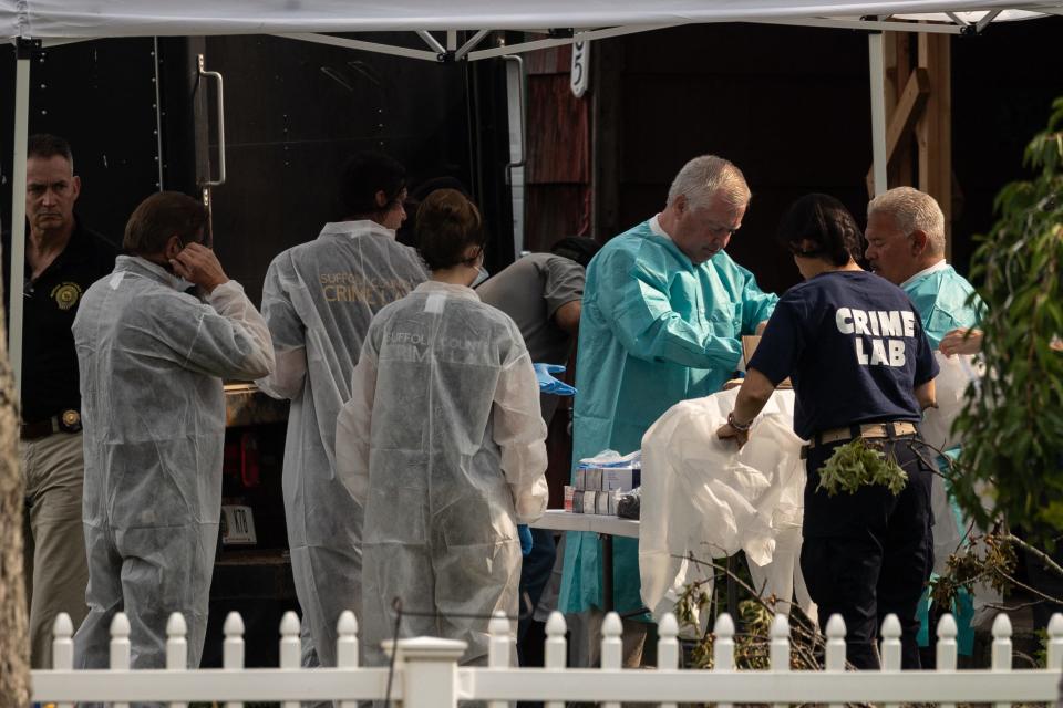 Crime laboratory officers prepare to search the home of Gilgo Beach murders suspect Rex Heuermann in Massapequa Park, New York, on July 18, 2023.