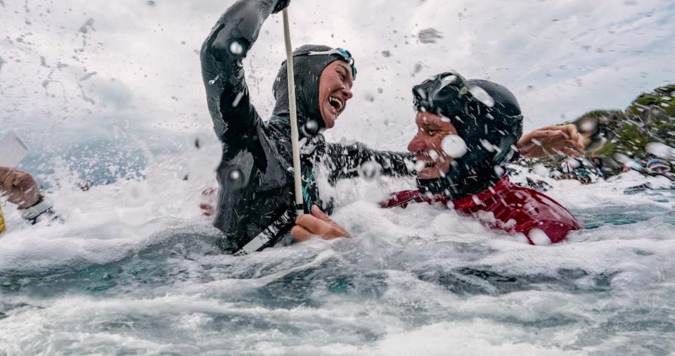 Alessia Zecchini (left) rises to the surface after a freedive and shares a smile with Stephen Keenan in "The Deepest Breath." Keenan died while safety diving for Zecchini in 2017.
