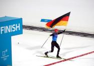 Nordic Combined Events - Pyeongchang 2018 Winter Olympics - Men's Team 4 x 5 km Final - Alpensia Cross-Country Skiing Centre - Pyeongchang, South Korea - February 22, 2018 - Johannes Rydzek of Germany waves the German flag as he crosses the finish line. REUTERS/Carlos Barria