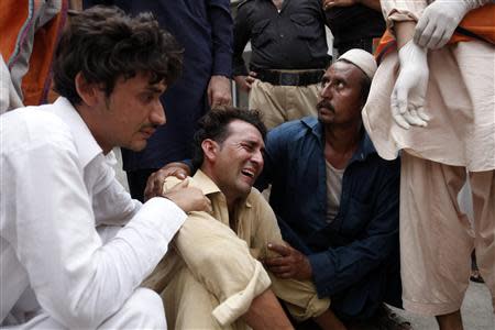 A man cries over the death of his brother, who was killed in a bomb blast, at a hospital in Peshawar September 27, 2013. REUTERS/Fayaz Aziz