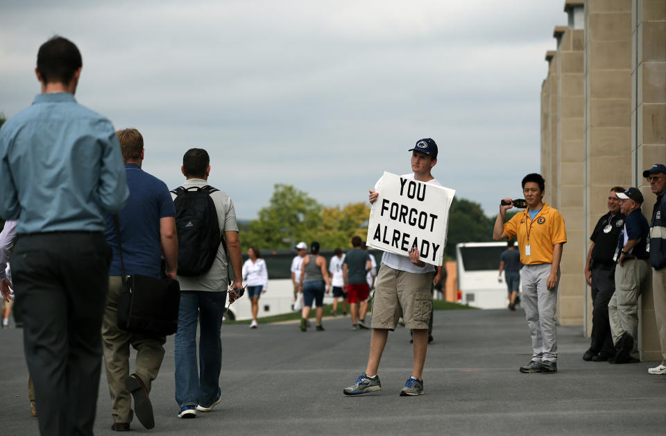 <p>Andrew Limauro, a sophomore from Pittsburgh Pa., stands outside Beaver Stadium protesting the school’s decision to honor former head coach Joe Paterno, before Penn State takes on Temple in an NCAA college football game in State College, Pa., Sept. 17, 2016. Paterno was fired in 2011 amid the Jerry Sandusky child sex abuse scandal. (Photo: Chris Knight/AP) </p>