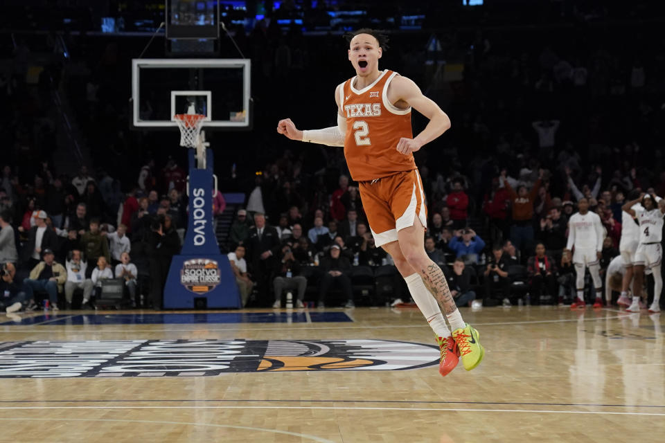 Texas's Chendall Weaver reacts after teammate Max Abmas sinks the winning shot during the second half of an NCAA college basketball game against Louisville, Sunday, Nov. 19, 2023, in New York. (AP Photo/Seth Wenig)