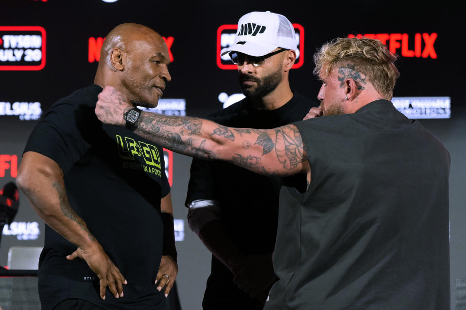 Mike Tyson, left, and Jake Paul, right, face off during a news conference promoting their upcoming boxing bout, Thursday, May 16, 2024, in Arlington, Texas. The fight is scheduled for July 20. (AP Photo/Sam Hodde)