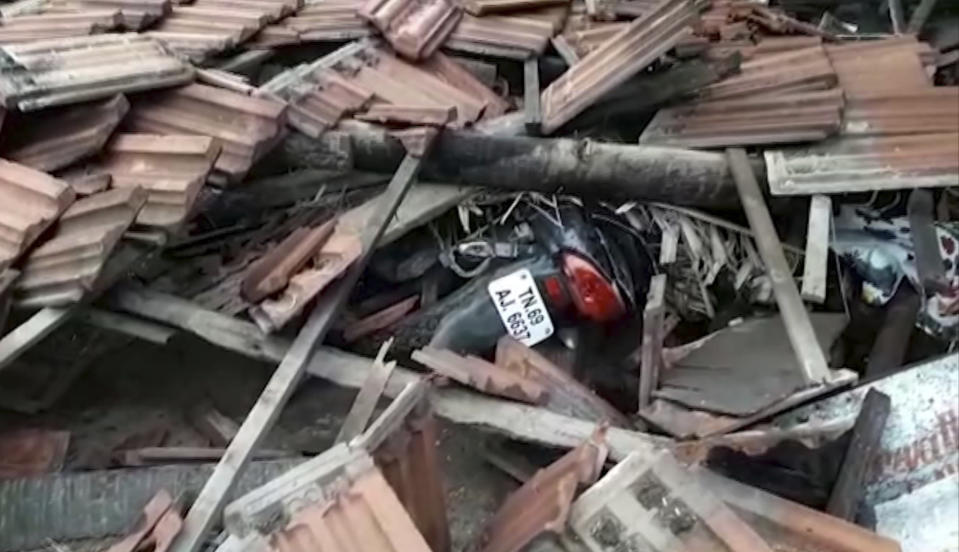 A motorcycle is covered in debris