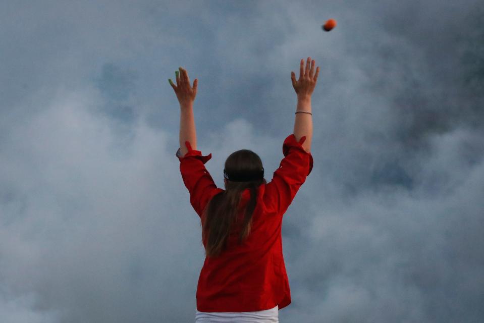 A projectile is fired over a protester by police hidden by a cloud of tear gas, Saturday, May 30, 2020, in Minneapolis.